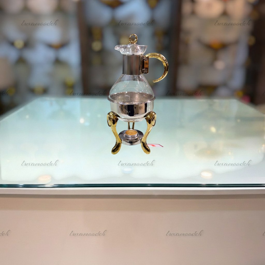 ظرف گرم نگهدارنده قهوه سافینوکس با بدنه شیشه‌ای و پایه استیل طلایی ، مناسب گرم نگه داشتن قهوه، چای و دمنوش، طراحی لوکس و مدرن با حلقه نگین‌دار